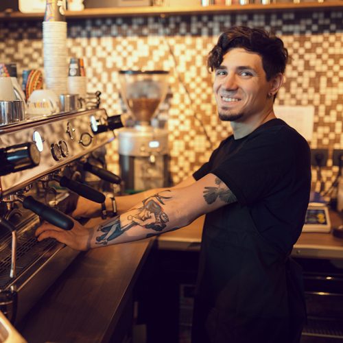 Barista at work in a coffee shop. Preparation service concept